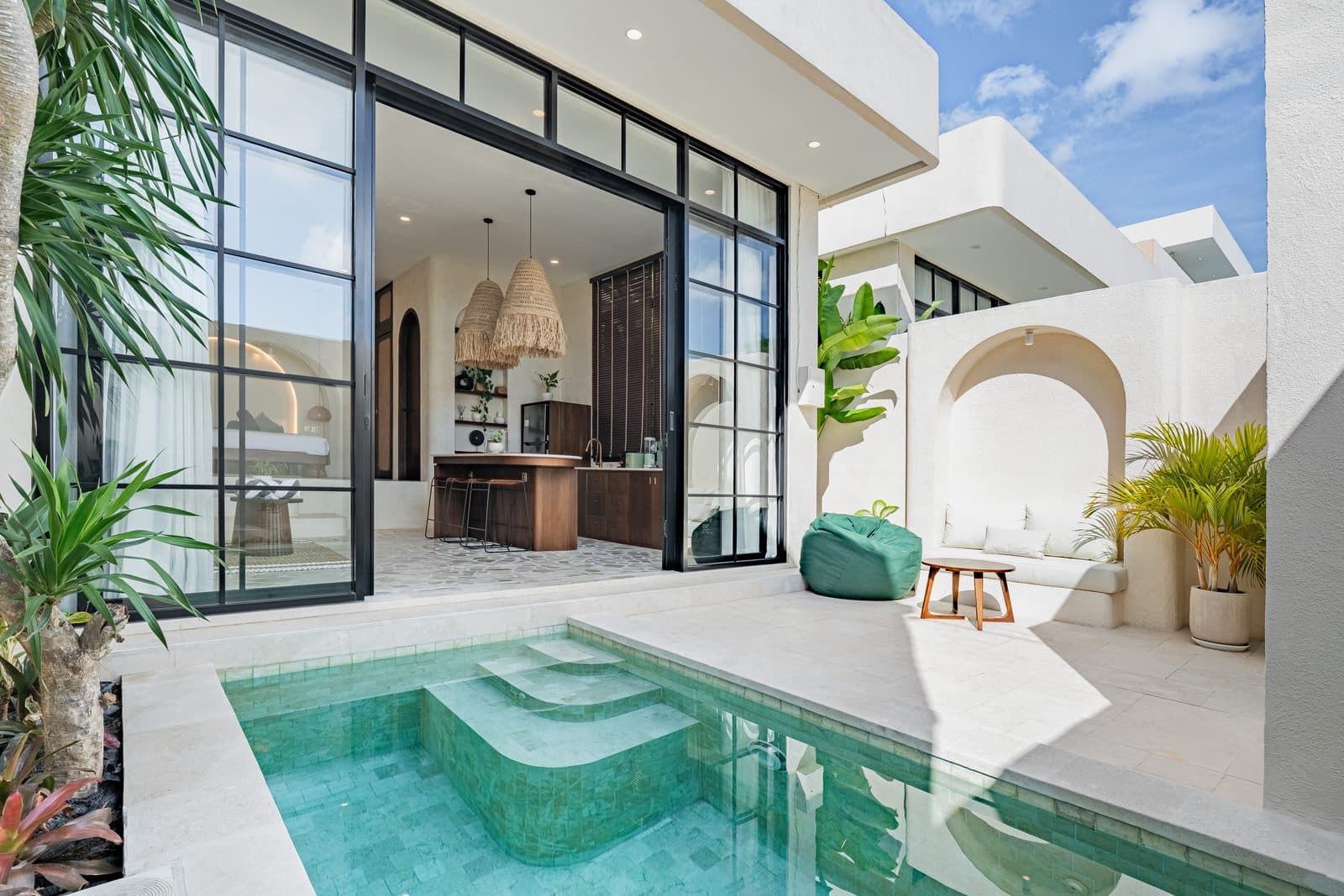 The plunge pool with the living room and kitchen opening onto it through full-height glass